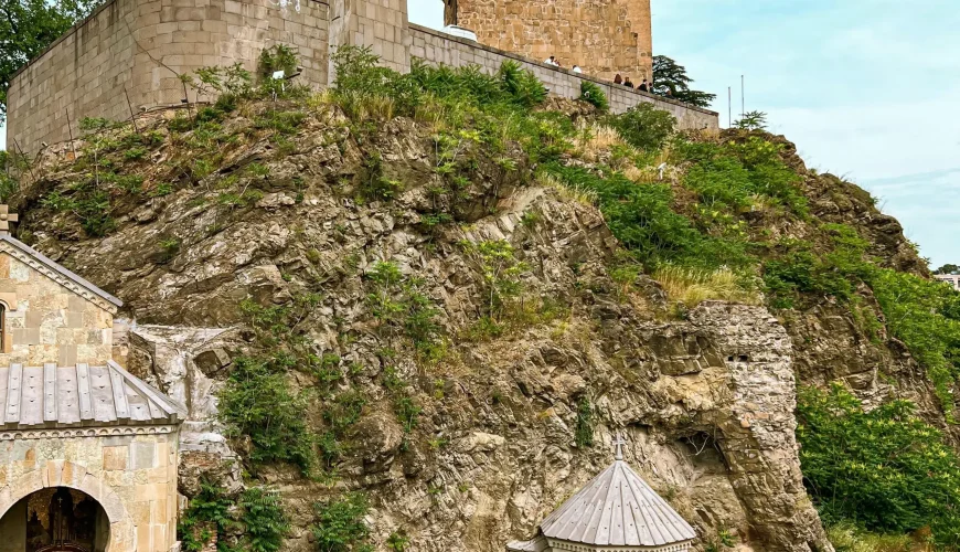 Metekhi Church and the equestrian statue of King Vakhtang Gorgasali on a rocky cliff overlooking the Mtkvari River in Tbilisi
