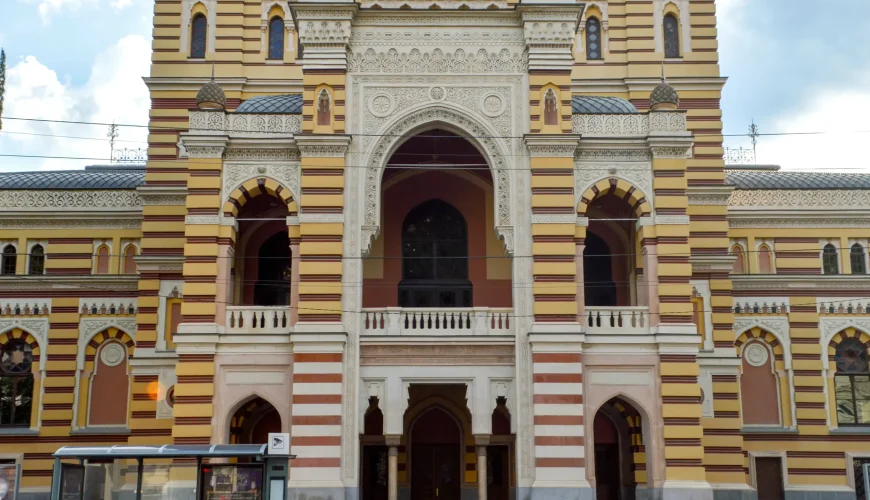 The ornate front facade of the Tbilisi Opera and Ballet Theatre with Moorish architectural details, arched windows, and a central entryway